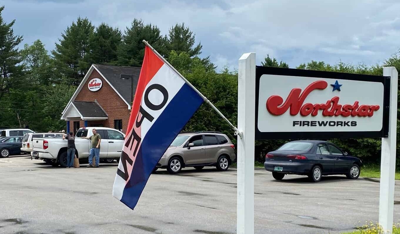Northstar Fireworks store exterior with an 'OPEN' flag and customers by parked vehicles.